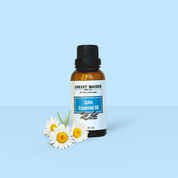 Essential oil bottle labeled 'Cheeky Maiden' with flowers on a light blue background
