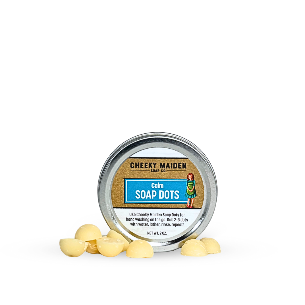 Container of Cheeky Maiden Soap Dots with soap dots on a white background