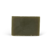 Green bar of soap on a white background
