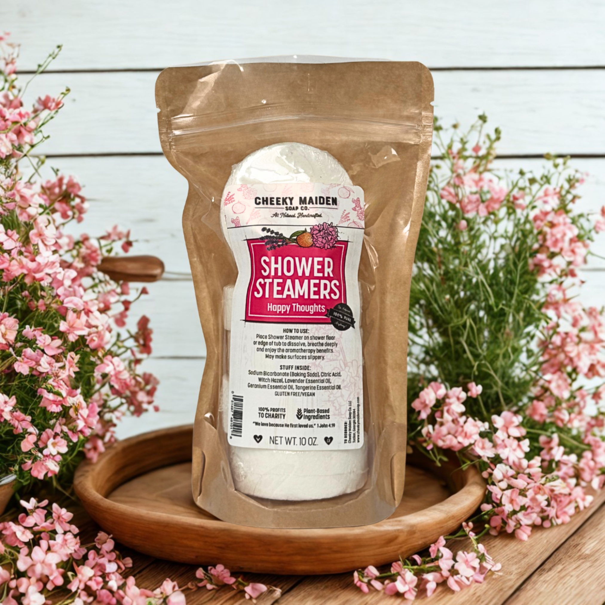 Packaged shower steamers with flowers on a wooden surface