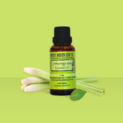 Bottle of Lemongrass essential oil with lemongrass stalks on a green background