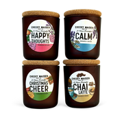 Four candles with labels indicating different scents on a white background