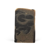 Bar of soap with black and brown marbled pattern on a white background