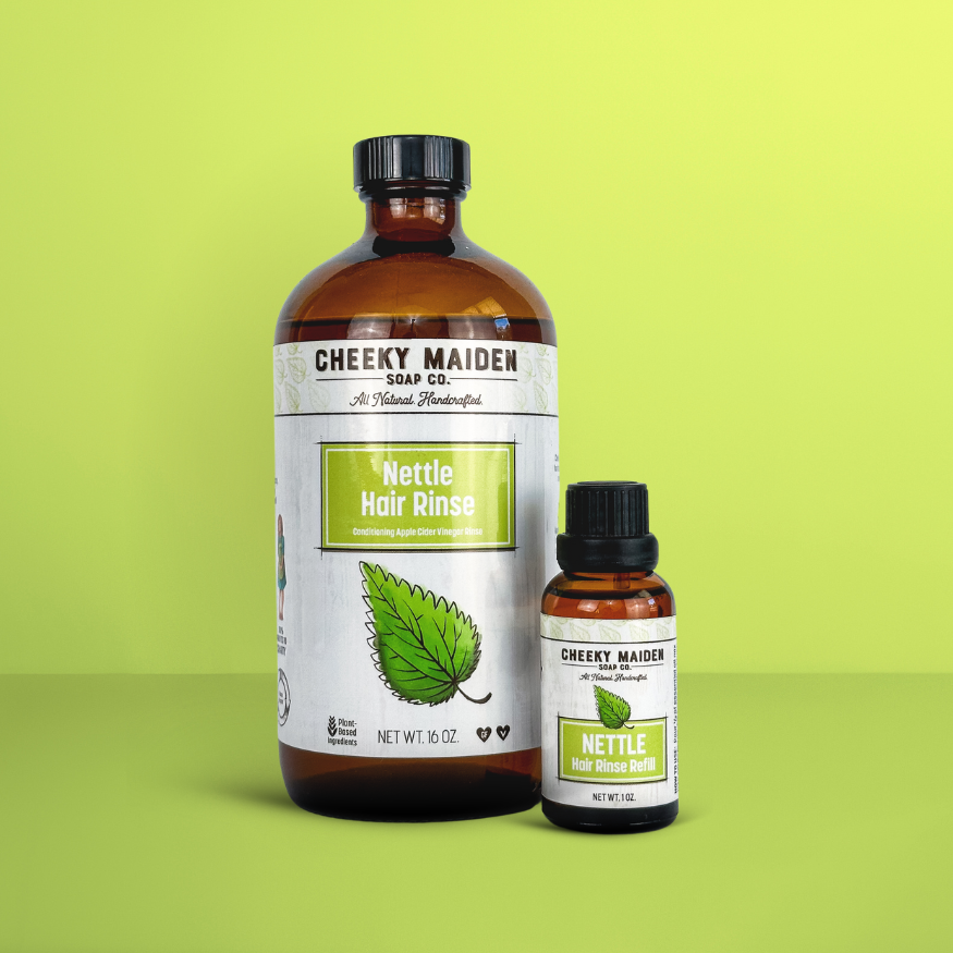 Two bottles of Cheeky Maiden Nettle Hair Rinse on a green background