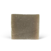 Square bar of soap with a speckled texture on a white background