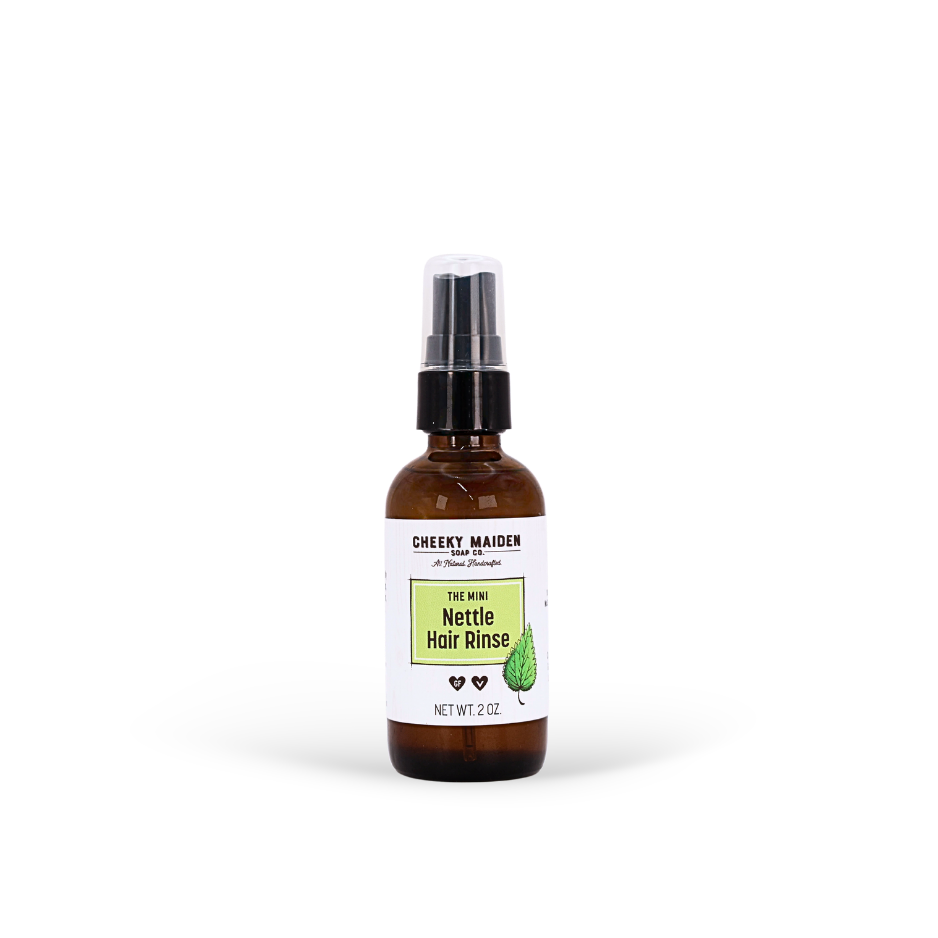Bottle of Nettle Hair Rinse with a white label on a white background