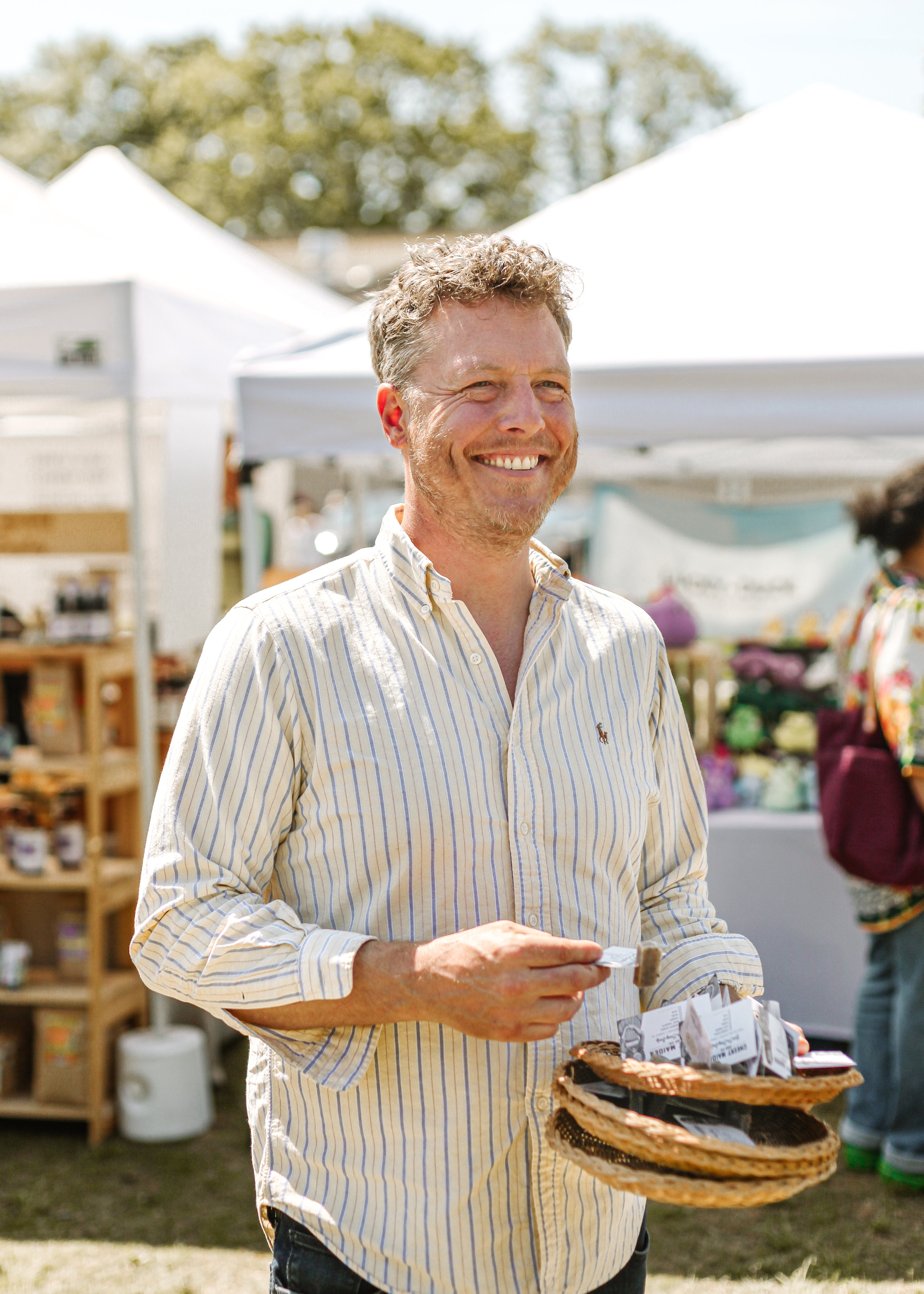 Nick holding soap samples at an outdoor market