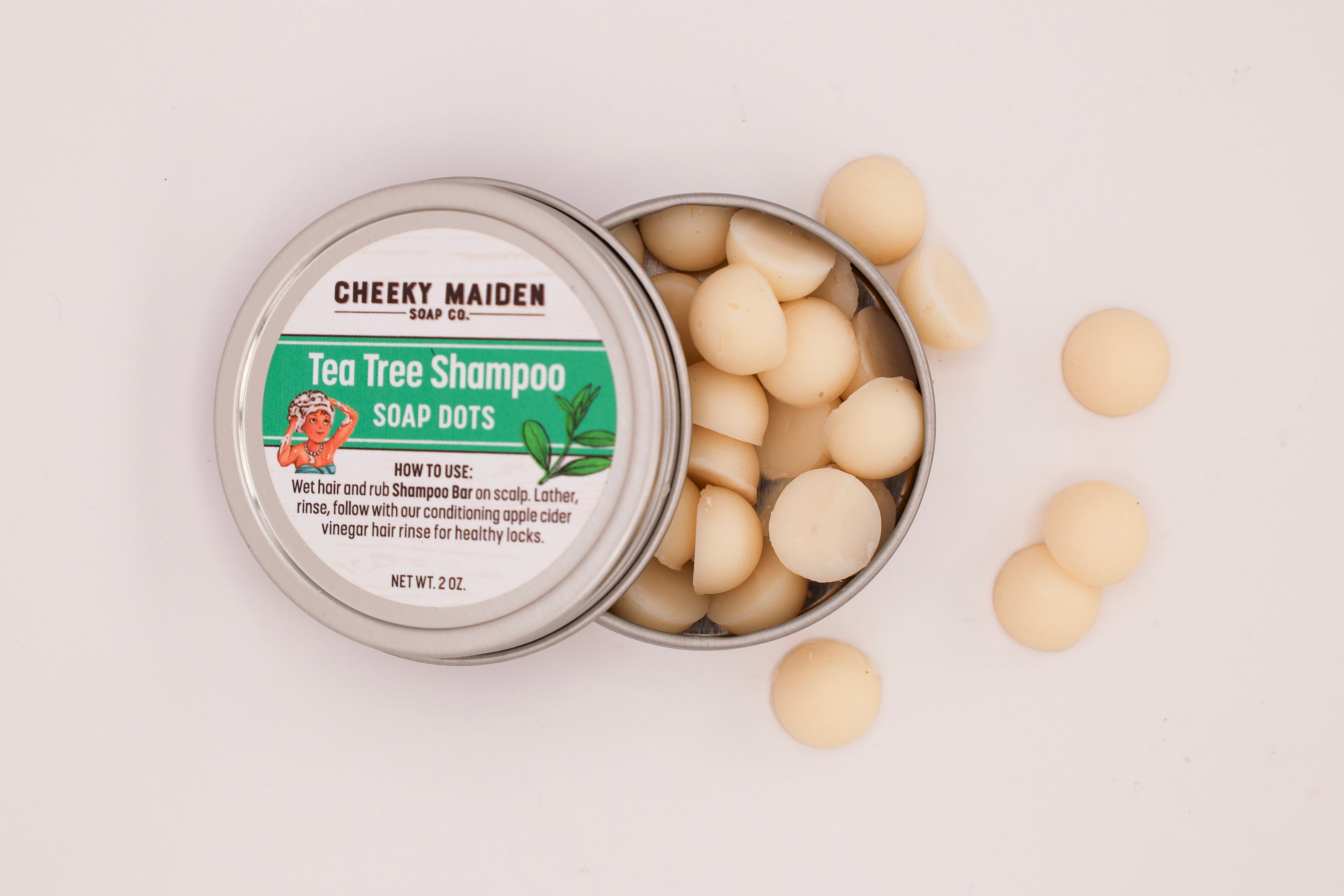 Cheeky Maiden Soap Co. tea tree shampoo soap dots in a metal tin on a light background