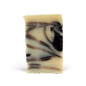 Marbled soap bar with brown and black swirls on a white background